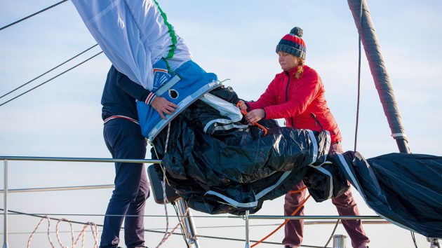 A snuffer allows a crew of two to handle a large asymmetric spinnaker with relative ease